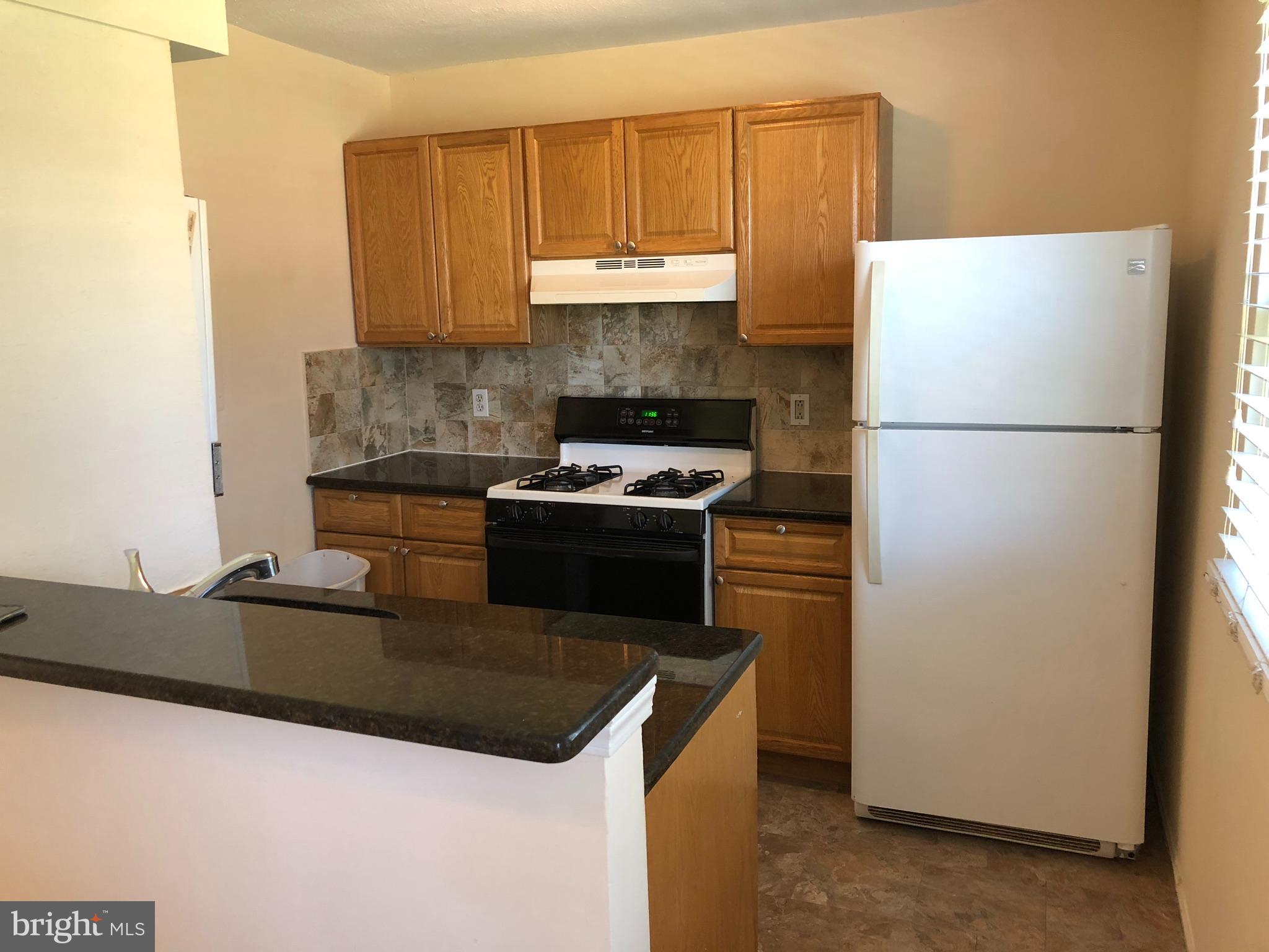100 Park Boulevard, Unit 75B Cherry Hill, NJ 08034 - Photo 5 of 12 a kitchen with granite countertop a refrigerator a stove and a sink