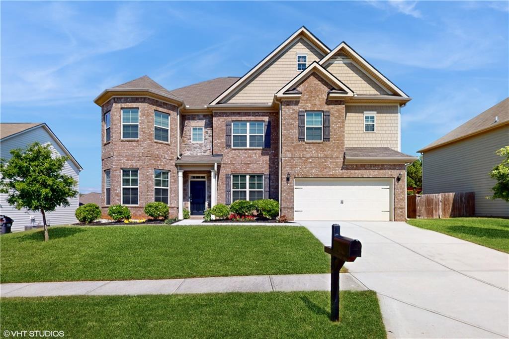 a front view of a house with a yard