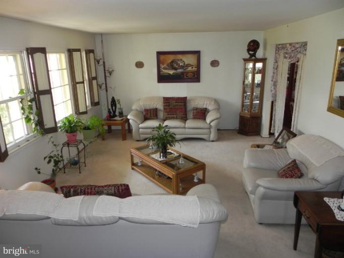 13006 Tamarack Road Silver Spring, MD 20904 - Photo 11 of 21 a living room with furniture and large windows
