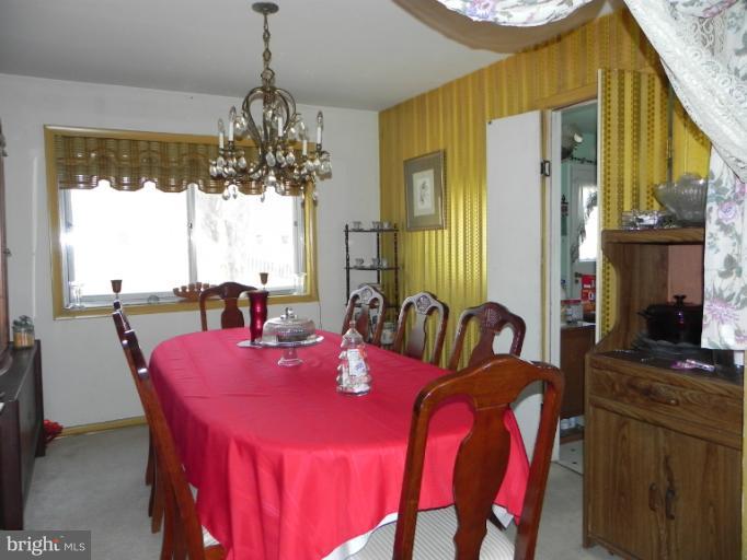 13006 Tamarack Road Silver Spring, MD 20904 - Photo 15 of 21 a dining room with furniture a chandelier and window