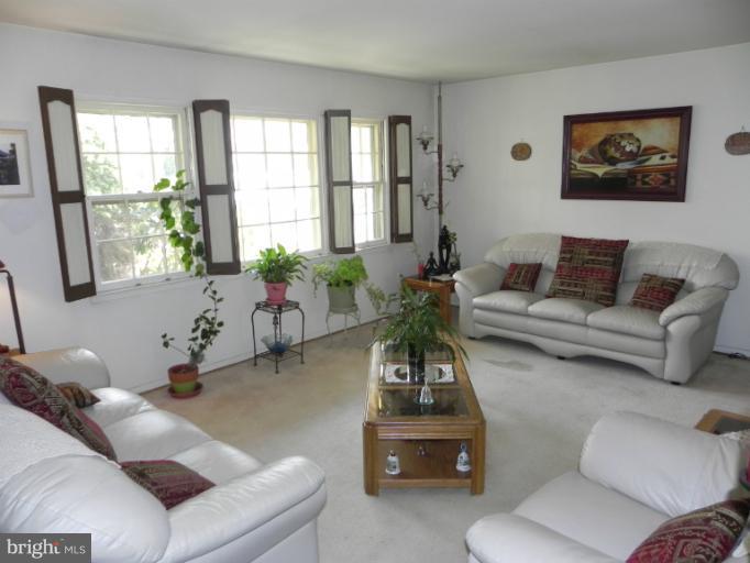 13006 Tamarack Road Silver Spring, MD 20904 - Photo 17 of 21 a living room with furniture and floor to ceiling windows