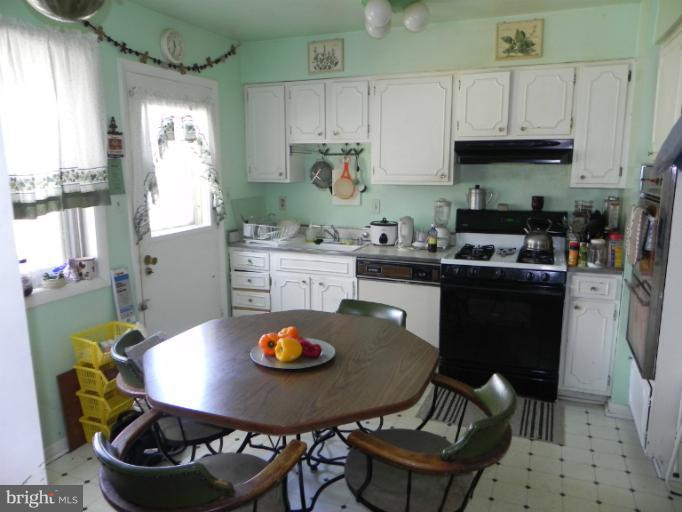 13006 Tamarack Road Silver Spring, MD 20904 - Photo 4 of 21 a kitchen with a sink a stove and chairs
