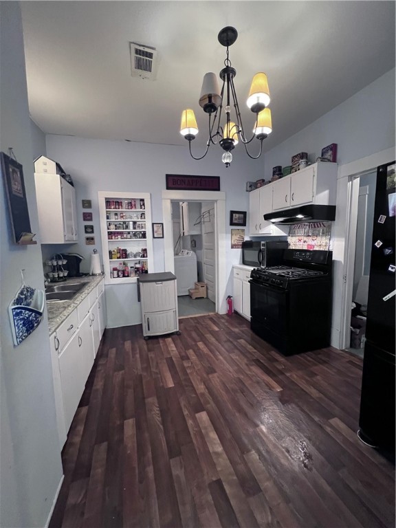 800 Ward Street Marlin, TX 76661 - Photo 12 of 22 a large kitchen with a wooden floor stainless steel appliances and cabinets