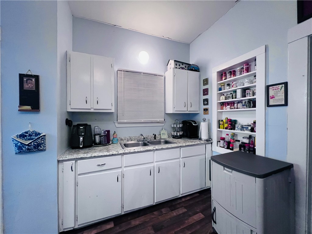 800 Ward Street Marlin, TX 76661 - Photo 14 of 22 a kitchen with a sink cabinets and wooden floor