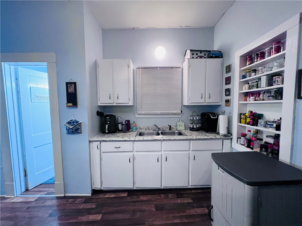 800 Ward Street Marlin, TX 76661 - Photo 15 of 22 a kitchen with stainless steel appliances a stove a sink and white cabinets