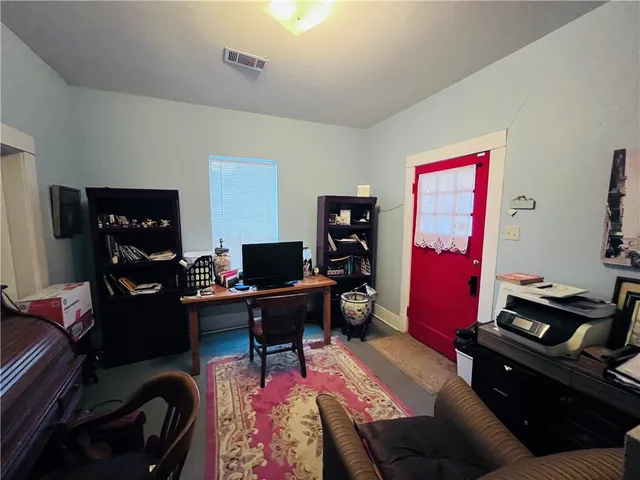 a livingroom with workspace and a couch