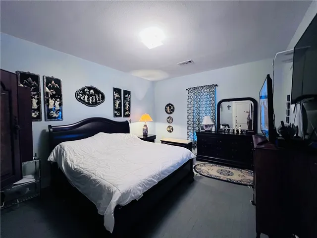 a bedroom with a bed and dresser
