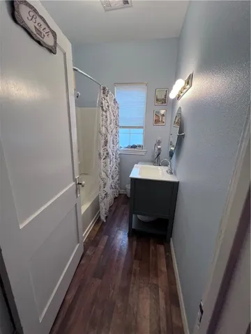 a bathroom with a sink a mirror and shower