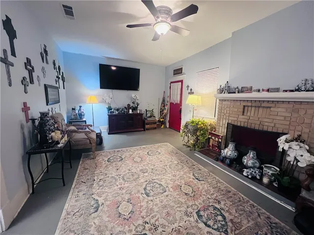 a living room with furniture and a fireplace
