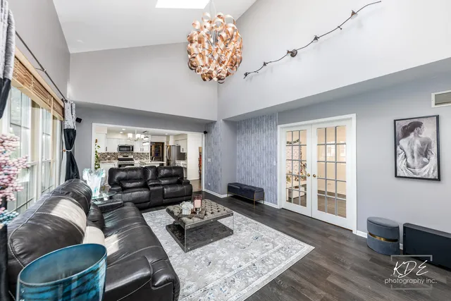 a living room with furniture and a chandelier