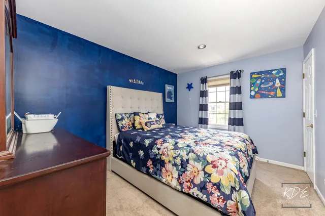 a bedroom with a bed and dresser