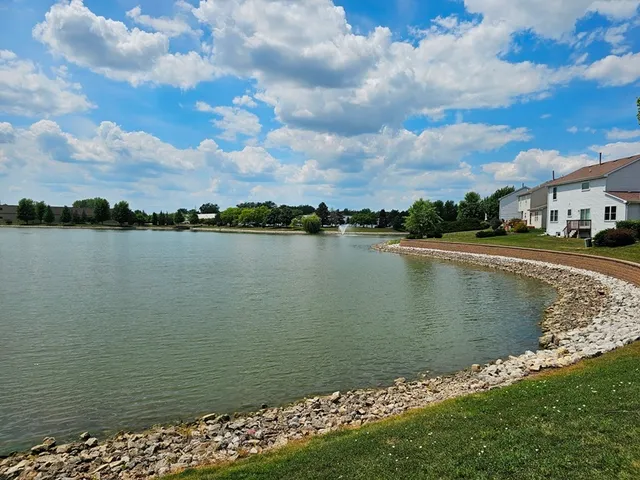 a view of a lake with houses in the background