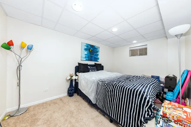 a bedroom with a bed and a painting on the wall