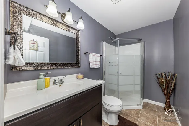 a bathroom with a sink a toilet and mirror