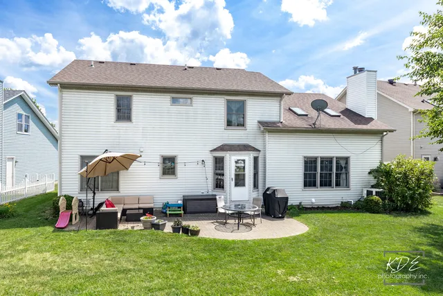 a front view of house with yard and outdoor seating