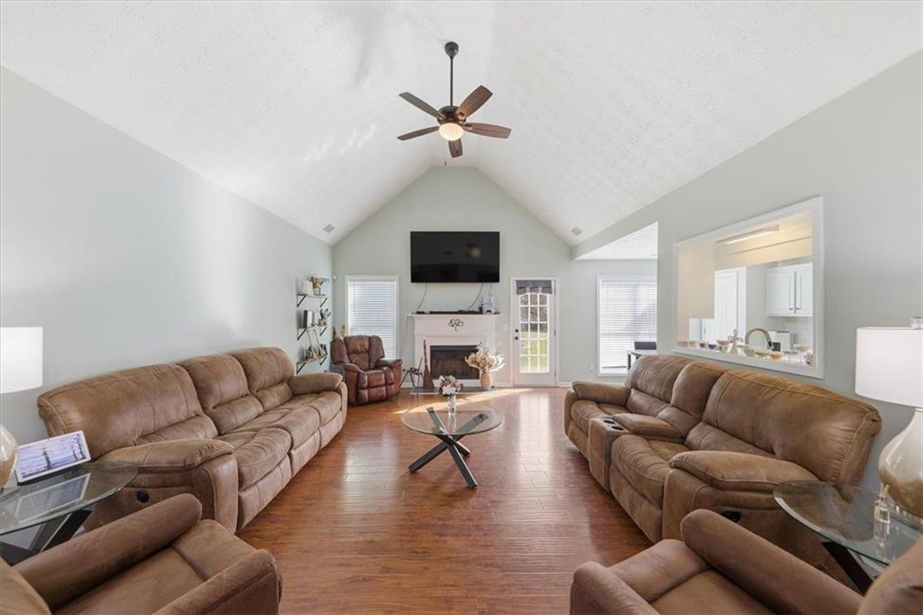 493 Youth Jersey Road Covington, GA 30014 - Photo 8 of 52 a living room with furniture a fireplace and a flat screen tv