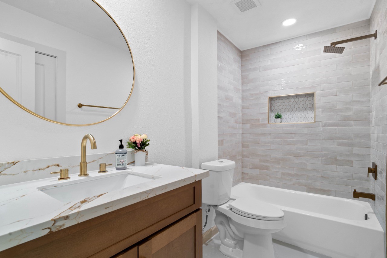 5326 Findlay Drive Pasadena, TX 77505 - Photo 43 of 50 Beautifully renovated secondary bathroom featuring a designer vanity, quartz countertop, custom tile surround, and built-in shower niche.