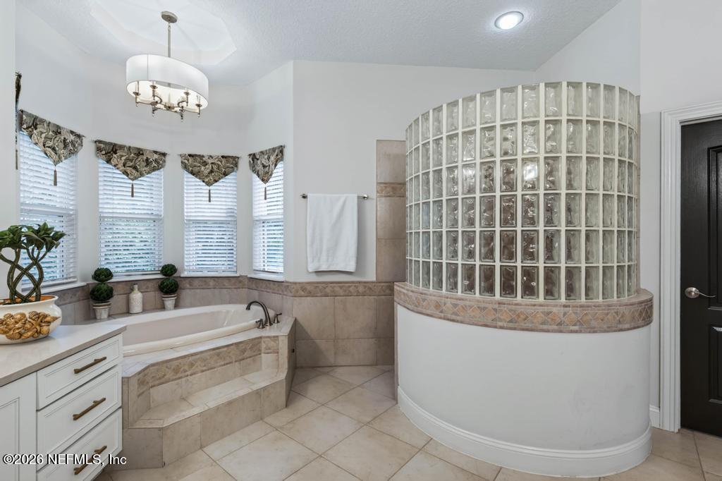 1483 Bridgette Way Fleming Island, FL 32003 - Photo 42 of 63 a bathroom with a tub sink and mirror