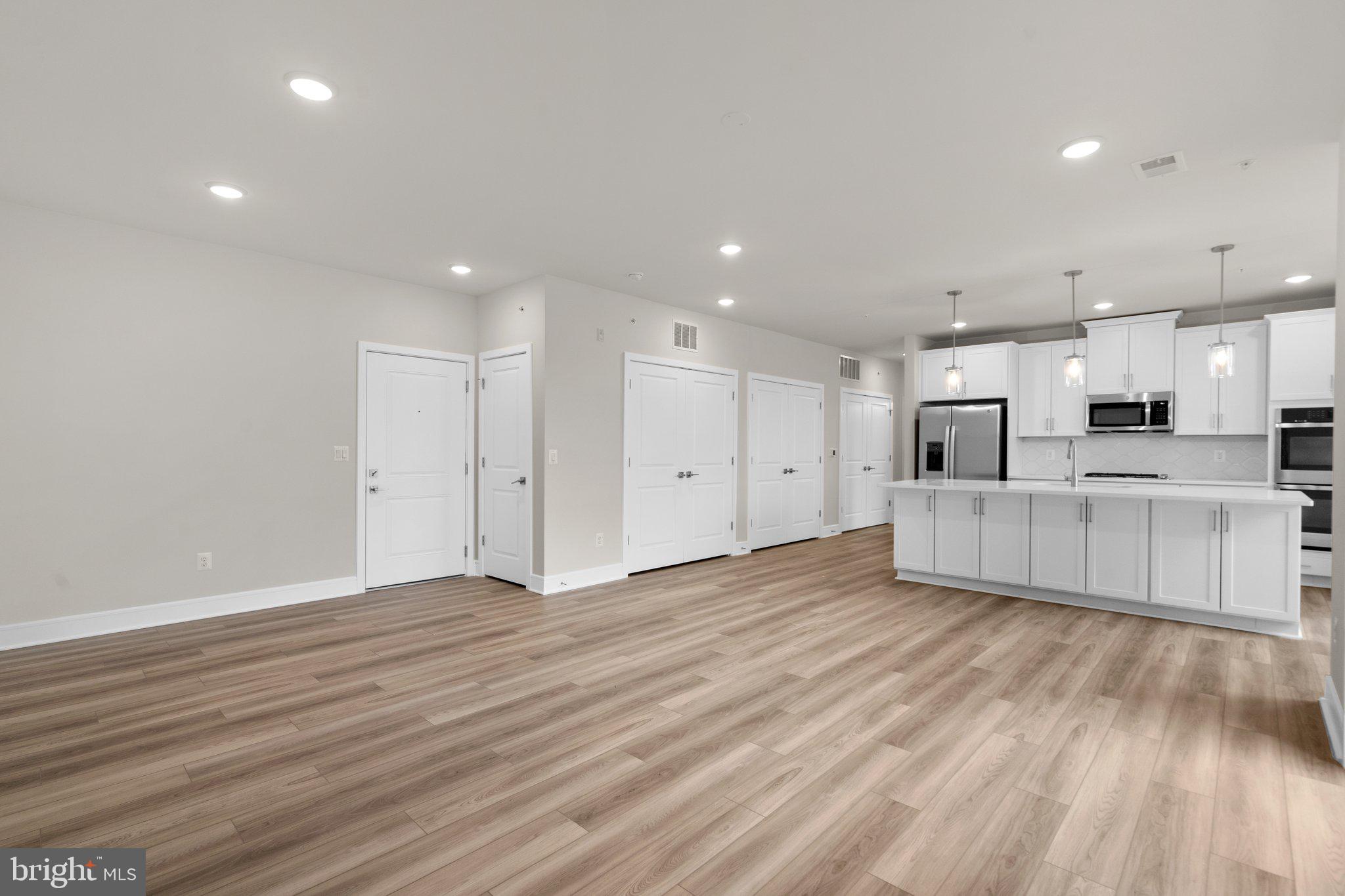 23688 Bolton Cres Terrace, Unit 11302 Ashburn, VA 20148 - Photo 1 of 30 a view of kitchen with wooden floor and window