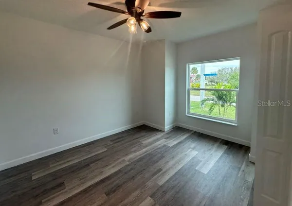a bathroom with a granite countertop sink a toilet and mirror