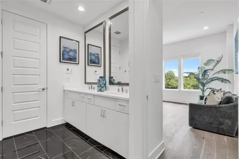 a bathroom with a double vanity sink and a mirror