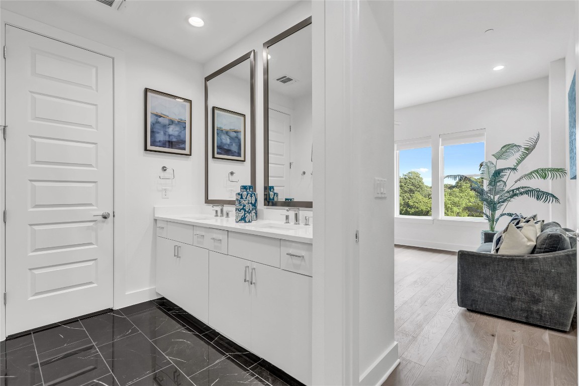 2505 Bluebonnet Lane, Unit 5 Austin, TX 78704 - Photo 19 of 35 a bathroom with a double vanity sink a mirror and a bathtub