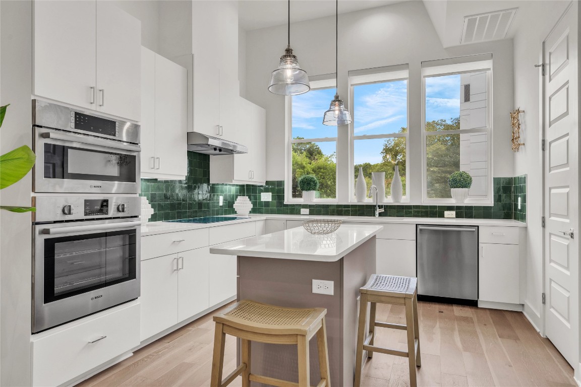2505 Bluebonnet Lane, Unit 5 Austin, TX 78704 - Photo 3 of 35 a kitchen with stainless steel appliances granite countertop a stove a sink and a refrigerator