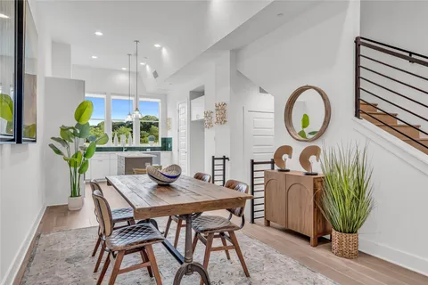 a dining room with furniture and a potted plant