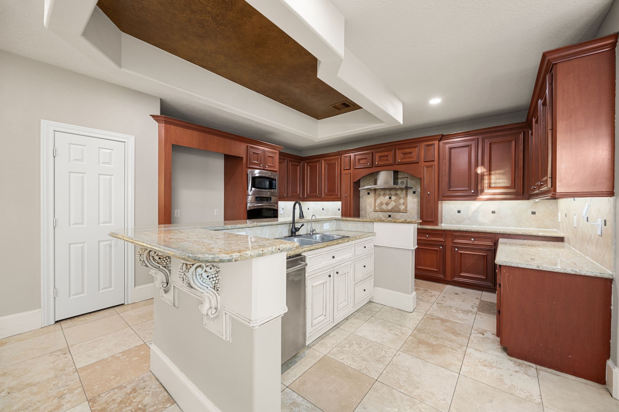 18921 Mountain Spring Drive Spring, TX 77379 - Photo 15 of 40 a kitchen with stainless steel appliances granite countertop a stove sink and cabinets