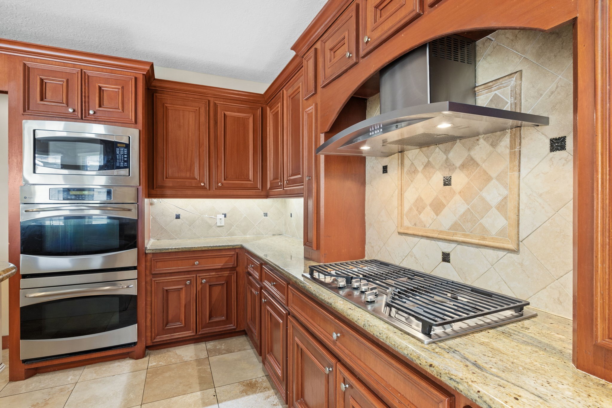 18921 Mountain Spring Drive Spring, TX 77379 - Photo 18 of 40 a kitchen with stainless steel appliances granite countertop a stove and a microwave
