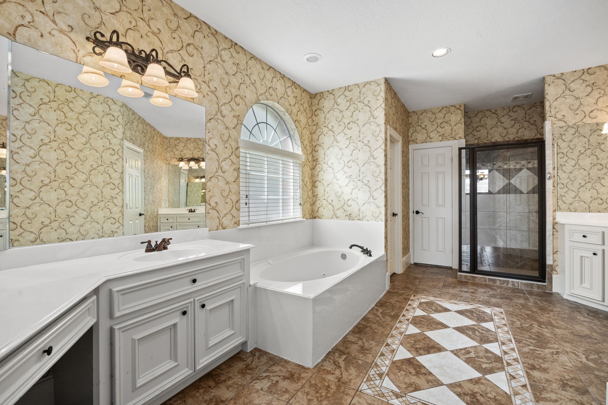18921 Mountain Spring Drive Spring, TX 77379 - Photo 25 of 40 a bathroom with a tub sink and mirror