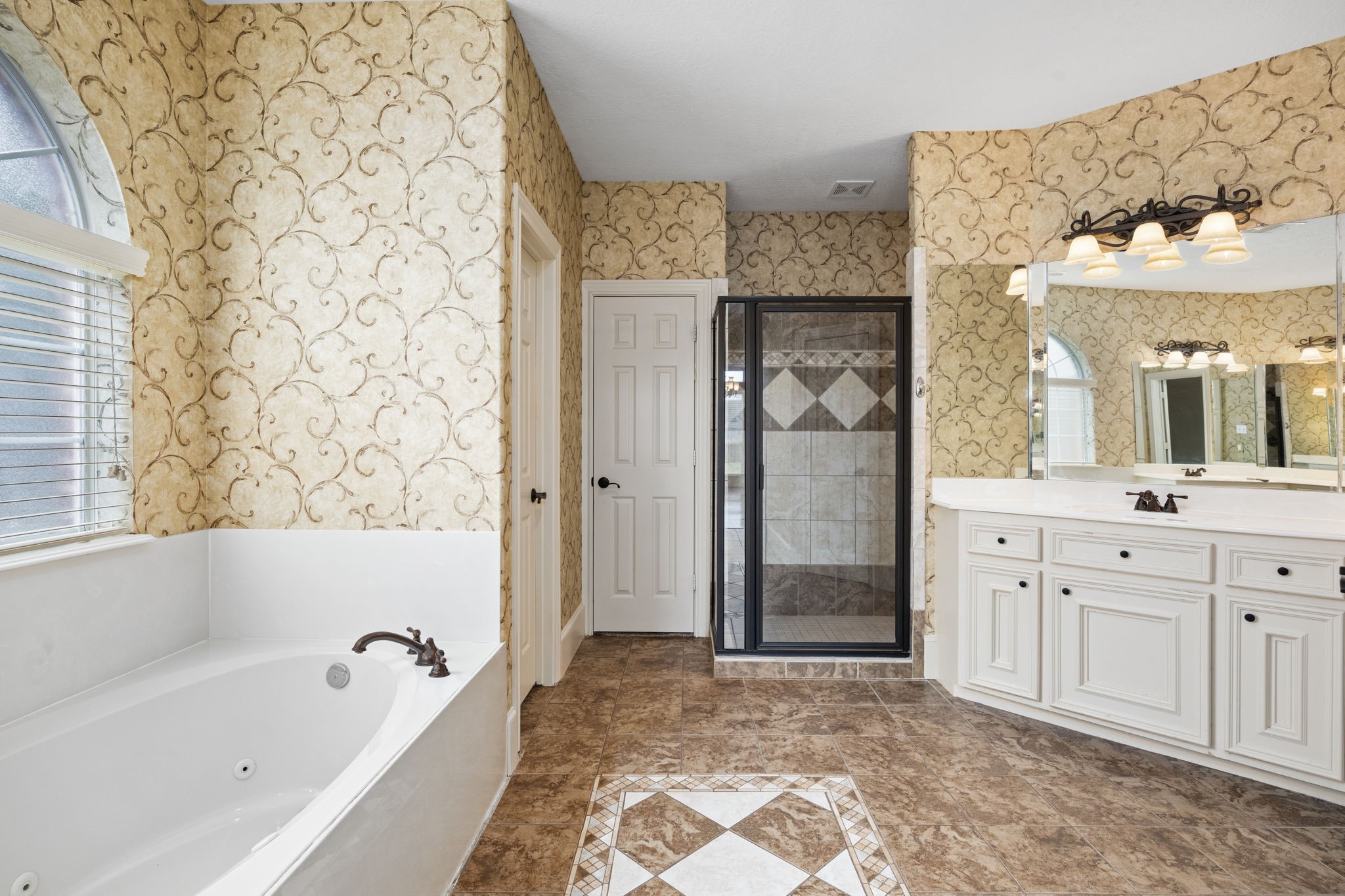 18921 Mountain Spring Drive Spring, TX 77379 - Photo 27 of 40 a bathroom with a bathtub sink and a shower