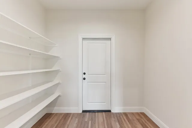 a large kitchen with stainless steel appliances granite countertop a sink a stove and a refrigerator