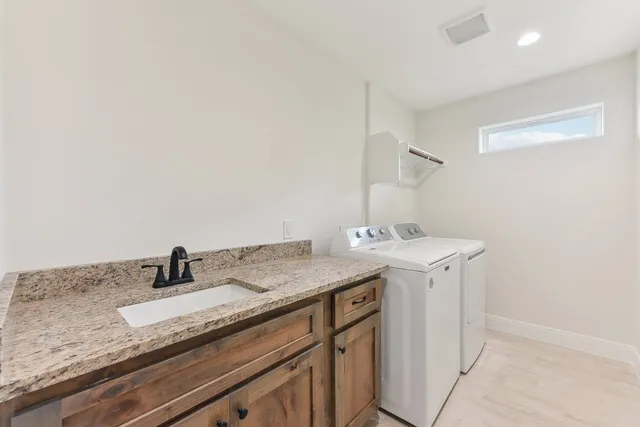 a bathroom with a granite countertop toilet a sink and mirror