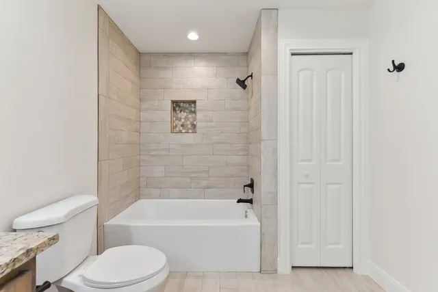 a view of empty room with wooden floor and window