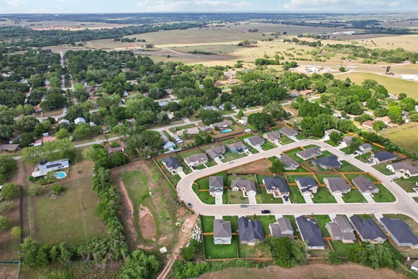 an aerial view of residential building with outdoor space and ocean view