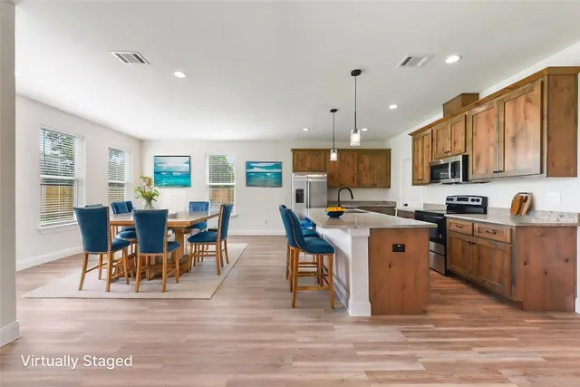 a view of kitchen with granite countertop cabinets table and chairs