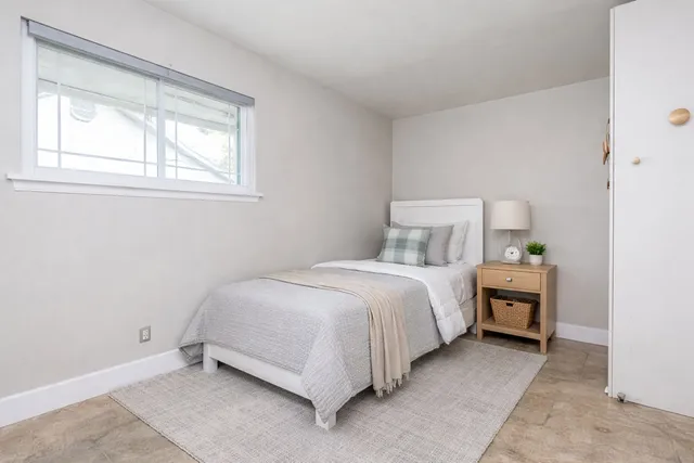 a bedroom with a bed and window