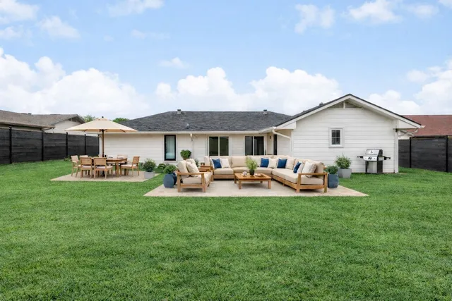 a front view of a house with garden and sitting area
