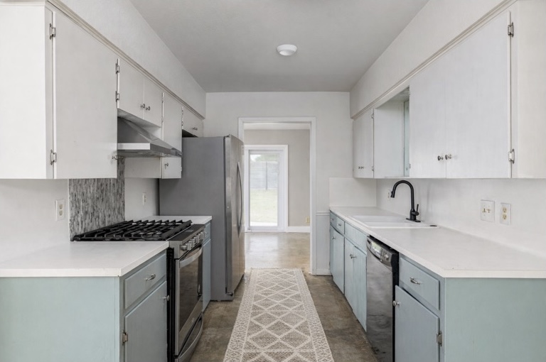 9506 Mountain Quail Road Austin, TX 78758 - Photo 4 of 19 The kitchen has a gas stove, and stainless-steel refrigerator. The concrete floors make for easy clean-up.