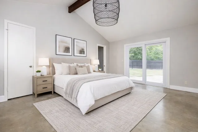 a bedroom with a large bed and a window