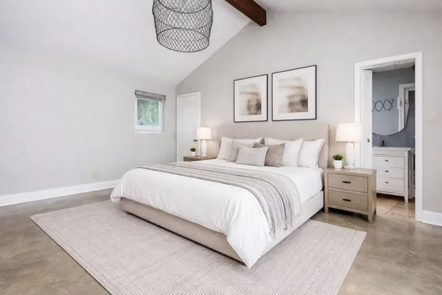 a bedroom with a bed a table and chair