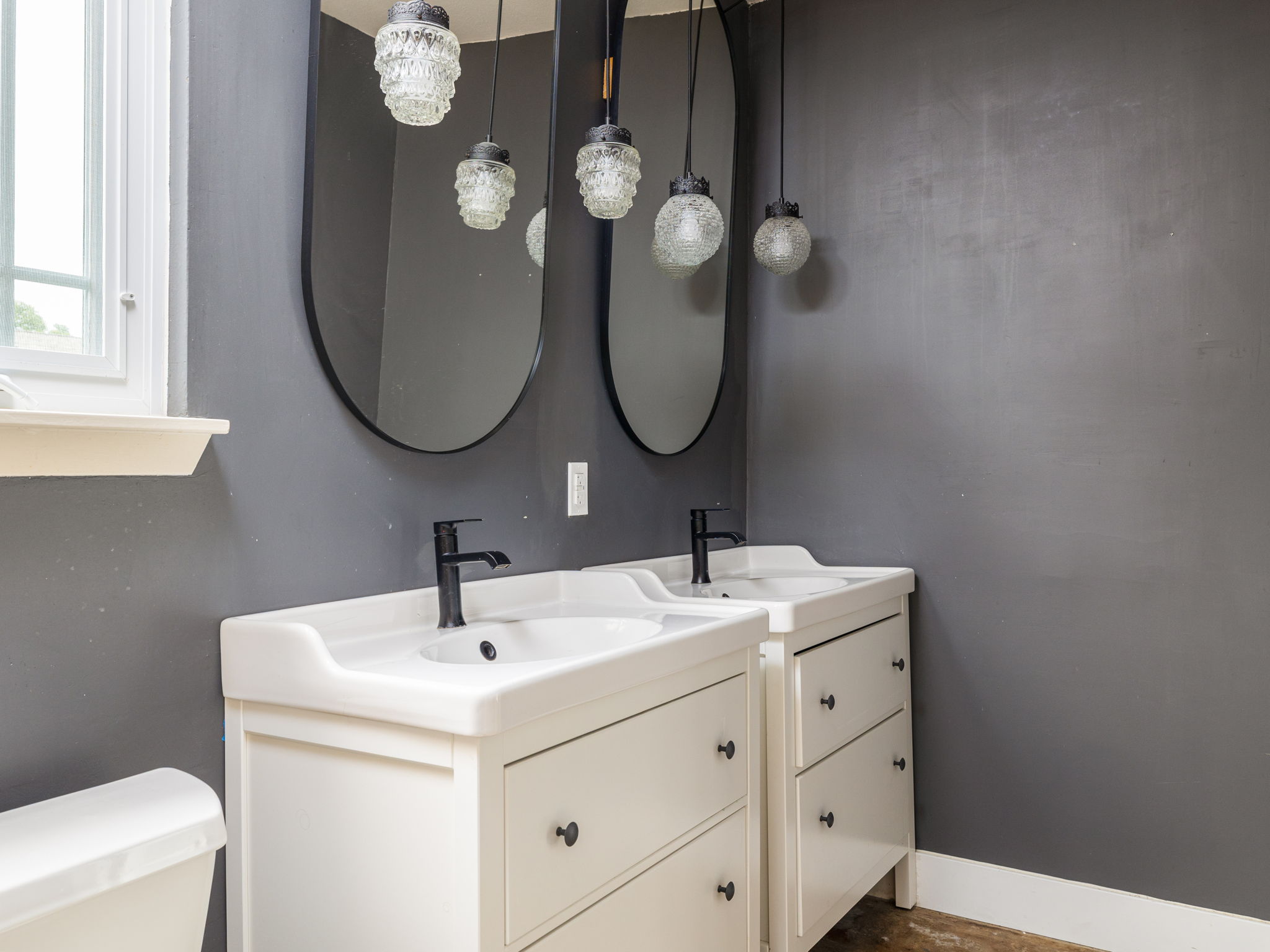 9506 Mountain Quail Road Austin, TX 78758 - Photo 10 of 19 Primary bathroom has two vanities, toilet, and walk-in shower.