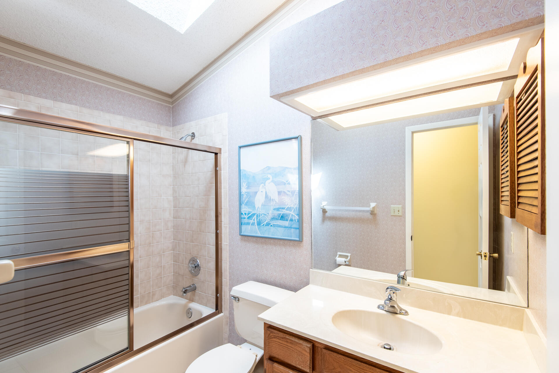 248 Rheine Road Northwest Palm Bay, FL 32907 - Photo 13 of 22 a bathroom with a sink mirror toilet and bathtub