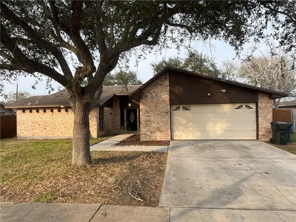 a view of a house with a large tree