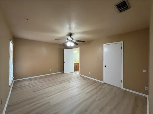 an empty room with a empty space and a ceiling fan
