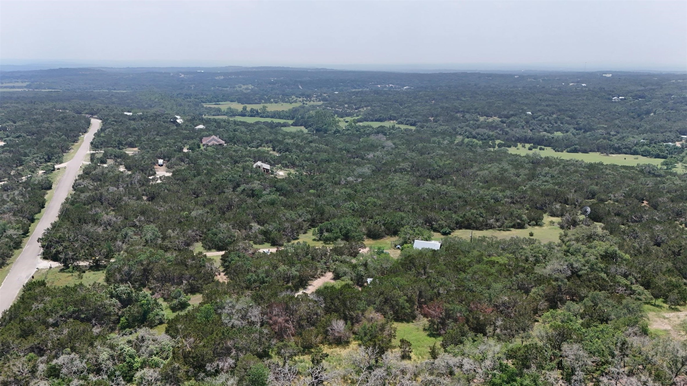 844 Plainview Road Wimberley, TX 78676 - Photo 8 of 10 an aerial view of house with yard and mountain view in back