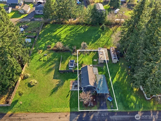 an aerial view of a house with a yard basket ball court