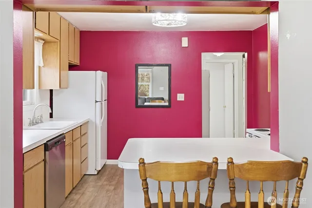a kitchen with a stove a sink and a refrigerator