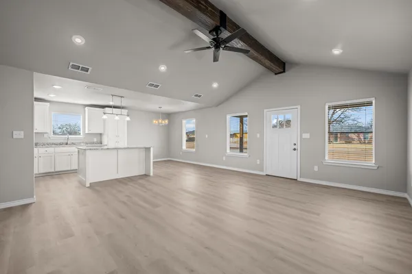 a view of a kitchen with a sink and a refrigerator